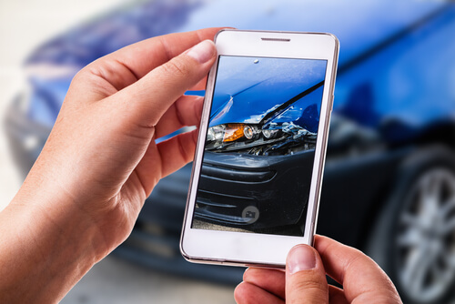 taking a picture of damaged car after a car accident