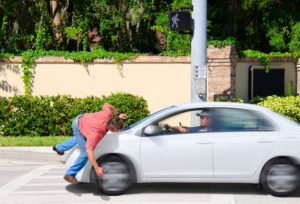 Car crashing into pedestrian on street