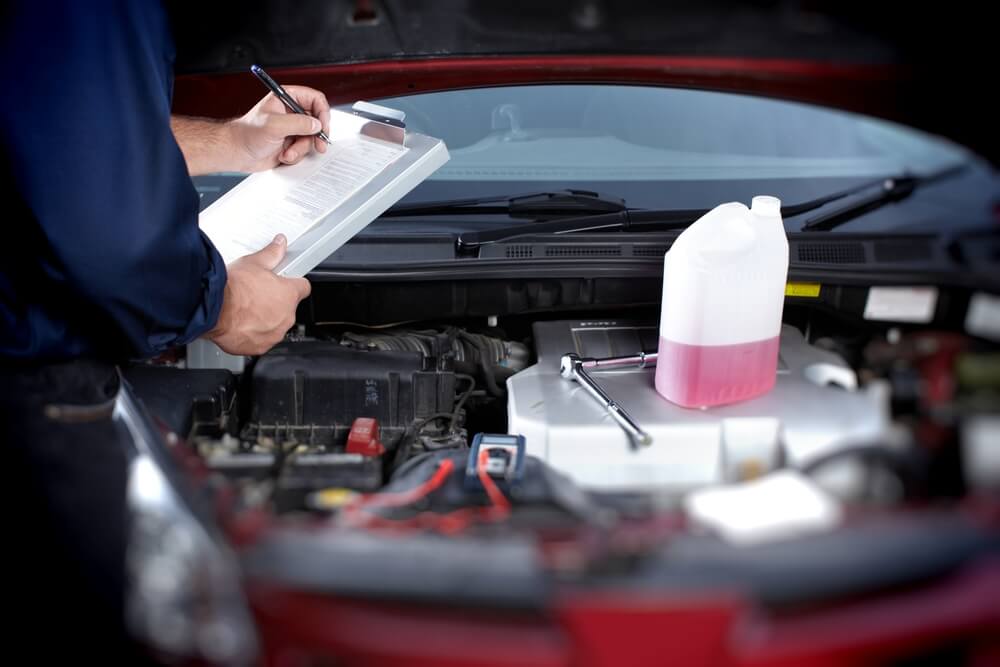 Mechanic working in auto repair garage. Car maintenance