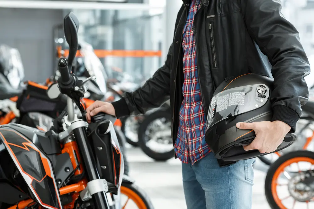 man standing near his motorcycle