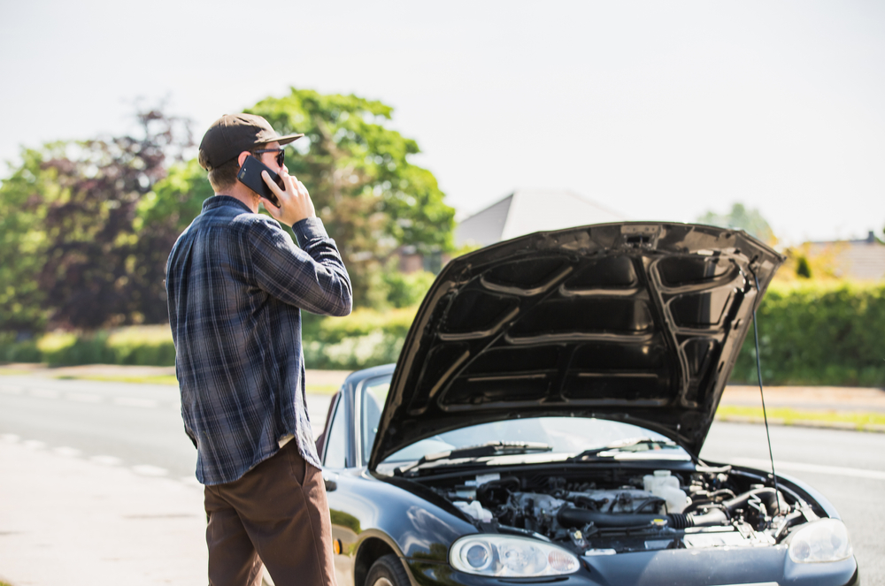 man calling insurance after car accident
