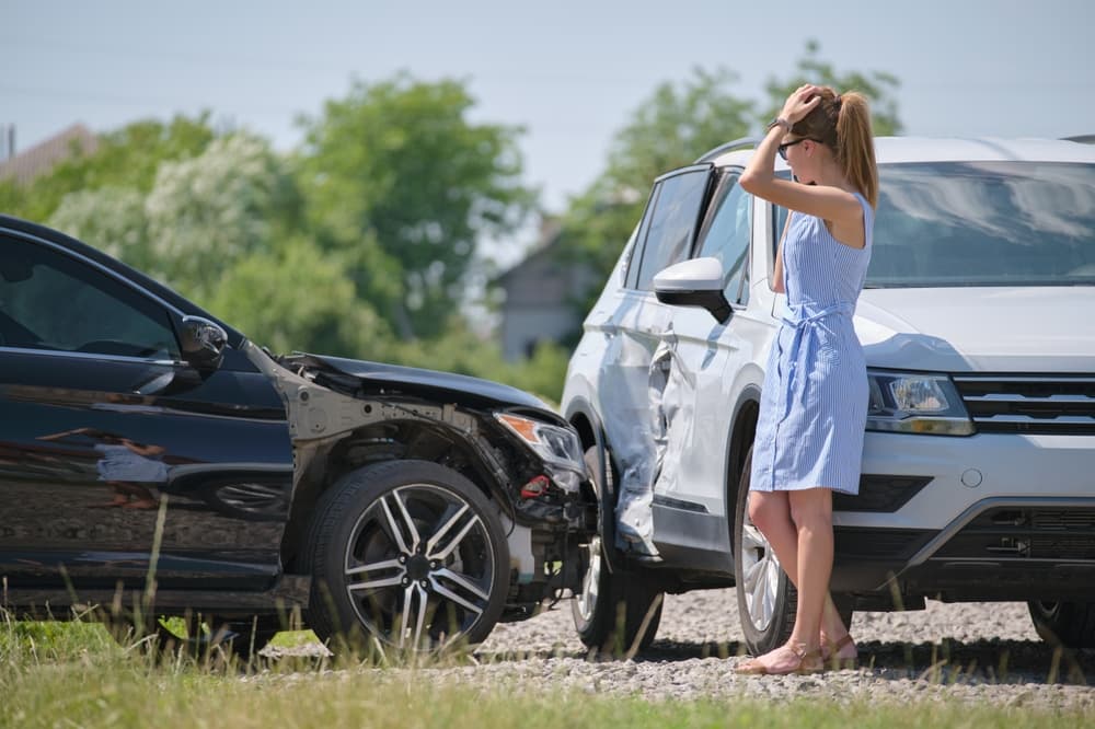 woman calling for emergency service after car accident