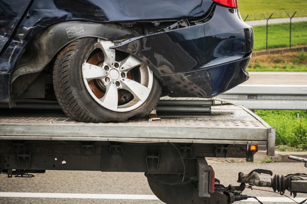 wrecked car being towed