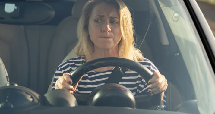 lady looking worried while driving