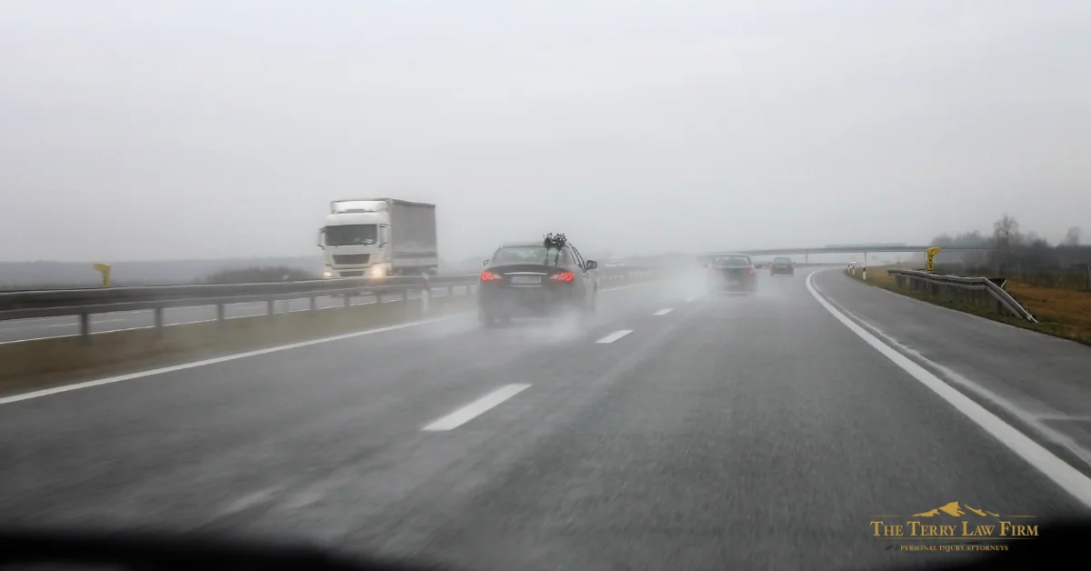 Semi-truck driving on a rain-slicked East Tennessee highway in foggy conditions