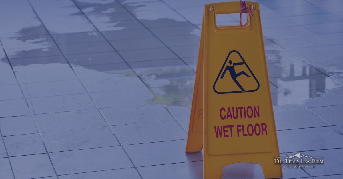 Yellow wet floor caution sign in a store aisle where a customer could slip